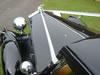 Close-up view of front of car with wedding ribbons
