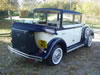 Rear corner view of car with roof down