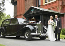 Wedding car with bride and groom