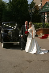Bride and groom with car