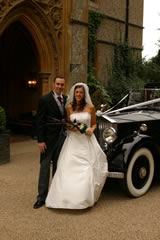 Bride and groom with car